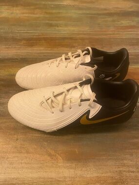 Nike Men’s White and Black Athletic Cleats with Gold Swoosh